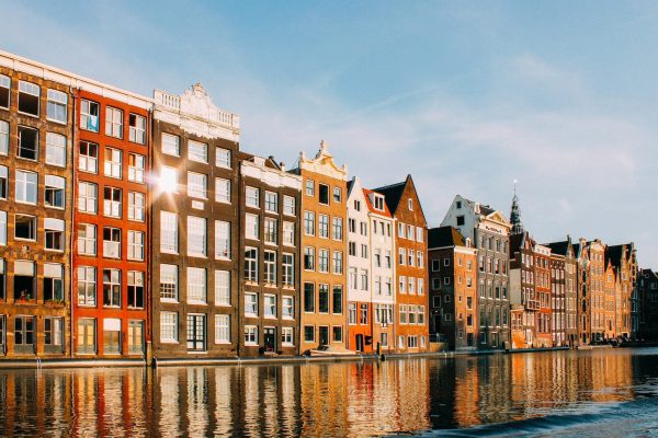 assorted-color buildings beside body of water